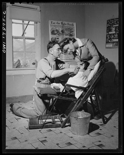 Questa, New Mexico. Dentist making an extraction in the clinic operated by the Taos county cooperative health association