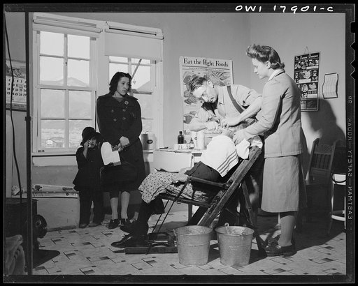 Questa, New Mexico. Dentist making an extraction in the clinic operated by the Taos County cooperative health association