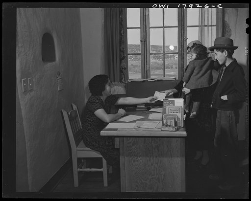 Questa, New Mexico. Patients registering with the secretary of the clinic operated by the Taos County cooperative health association