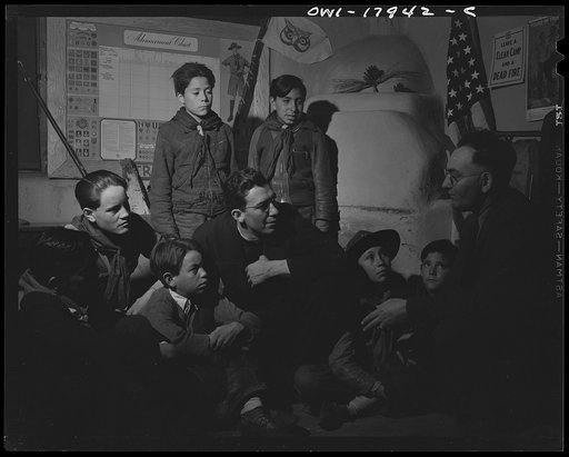 Taos County, New Mexico. Father Cassidy, the Catholic priest of the parish of Penasco with his troop of Boy Scouts listening to the local forest ranger discussing conservation of their forests