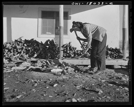 Penasco, New Mexico. Marjorie Muller, Red Cross resident nurse at the clinic operated by the Taos County cooperative health association, does her own cooking, cuts her own wood, and draws her own water