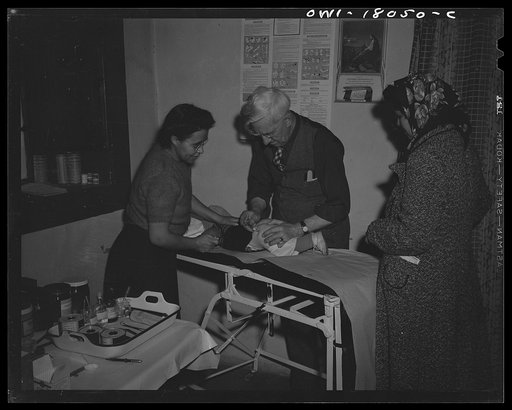 Untitled photo, possibly related to: Penasco, New Mexico. Doctor Onstine making an examination in the clinic operated by the Taos County cooperative health association