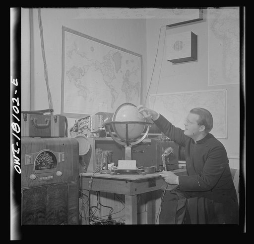 Questa, New Mexico. Father Smith broadcasting a news release in Spanish from his parish house broadcasting station