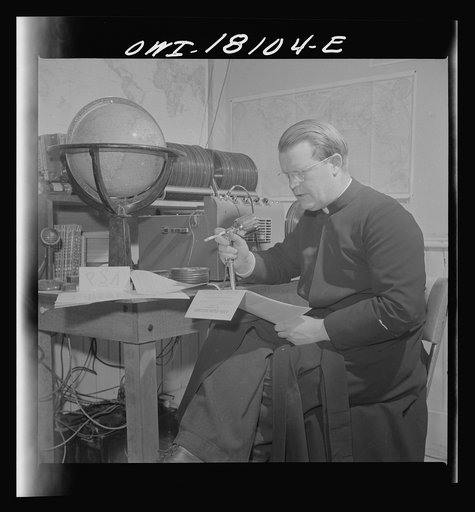 Questa, New Mexico. Father Smith broadcasting a news release in Spanish from his parish house broadcasting station