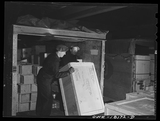 New York, New York. Associated Transport Company trucking terminal on Twenty-third Street. Unloading war goods from a truck