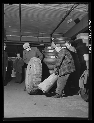 New York, New York. Associated Transport Company trucking terminal on Twenty-third Street. Loading tires onto a truck