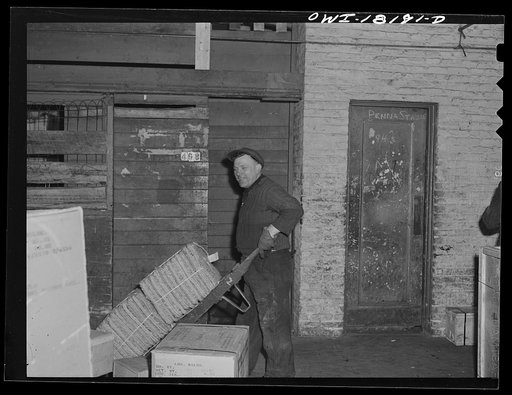 Untitled photo, possibly related to: New York, New York. Associated Transport Company trucking terminal on Washington Street. Unloading goods