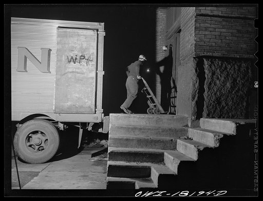 New York, New York. Associated Transport Company trucking terminal on Washington Street. Loading goods on a southbound transport truck