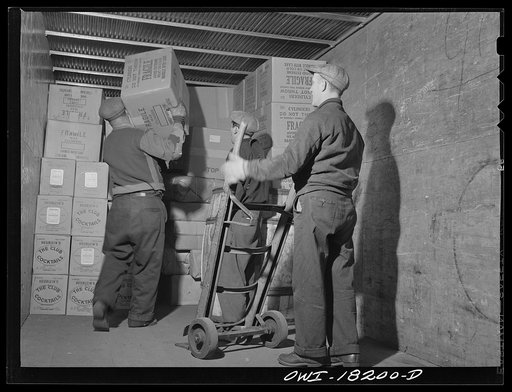 New York, New York. Associated Transport Company trucking terminal on Washington Street. Unloading goods