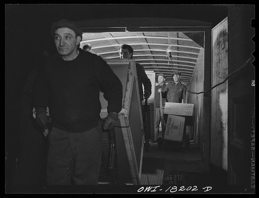 New York, New York. Associated Transport Company trucking terminal on Washington Street. Unloading goods
