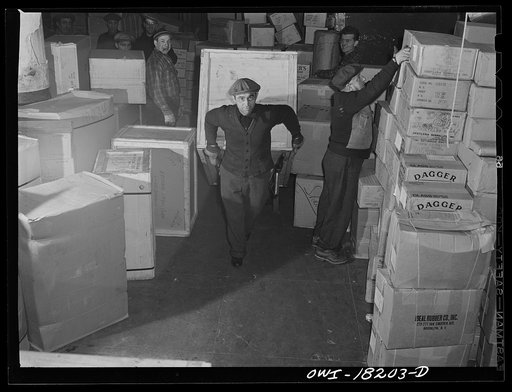 New York, New York. Associated Transport Company trucking terminal on Washington Street. Unloading goods