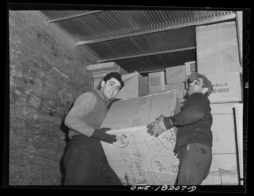 New York, New York. Associated Transport Company trucking terminal on Washington Street. Loading a truck