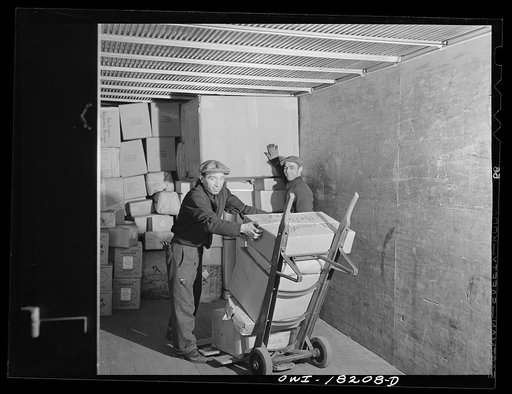New York, New York. Associated Transport Company trucking terminal on Washington Street. Loading a truck