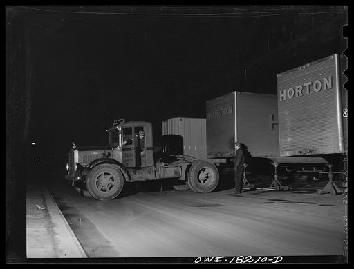 New York, New York. Associated Transport Company trucking terminal on Washington Street. Backing a tractor to a loaded trailer which is going south
