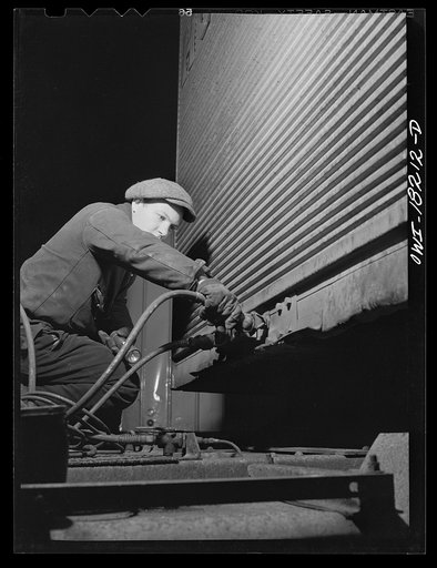 New York, New York. Associated Transport Company trucking terminal on Washington Street. Attaching air lines from the tractor to the trailer
