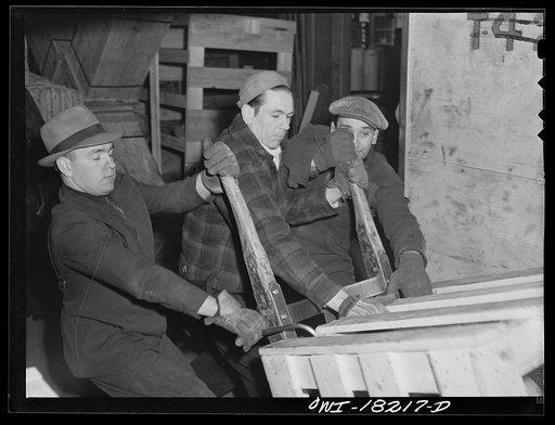 New York, New York. Associated Transport Company trucking terminal on Twenty-third Street. Unloading goods from a local truck