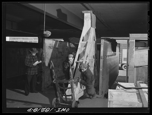 New York, New York. Associated Transport Company trucking terminal on Twenty-third Street. Unloading an airplane propeller