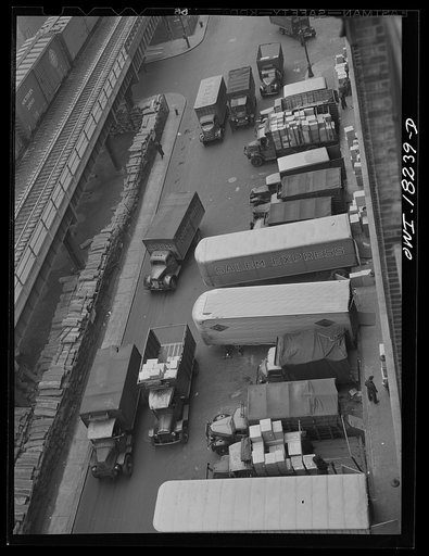 Untitled photo, possibly related to: New York, New York. Associated Transport Company trucking terminal on Twenty-third Street. Main line and local delivery trucks at the loading platform