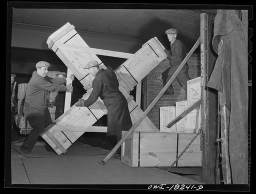 New York, New York. Associated Transport Company trucking terminal on Washington Street. Unloading airplane propeller from a truck