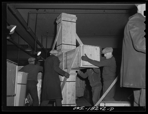 New York, New York. Associated Transport Company trucking terminal on Washington Street. Unloading airplane propeller from a truck
