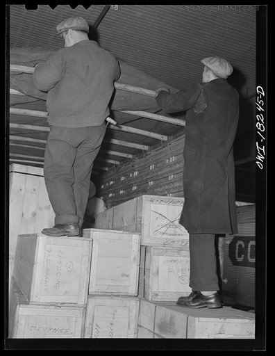 Untitled photo, possibly related to: New York, New York. Associated Transport Company trucking terminal on Twenty-third Street. Unloading goods