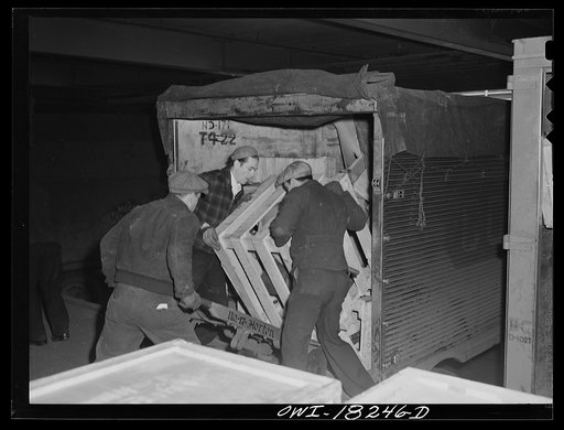 New York, New York. Associated Transport Company trucking terminal on Twenty-third Street. Unloading goods