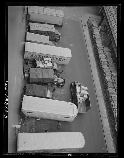New York, New York. Associated Transport Company trucking terminal on Twenty-third Street. Main line and local delivery trucks at the loading platform