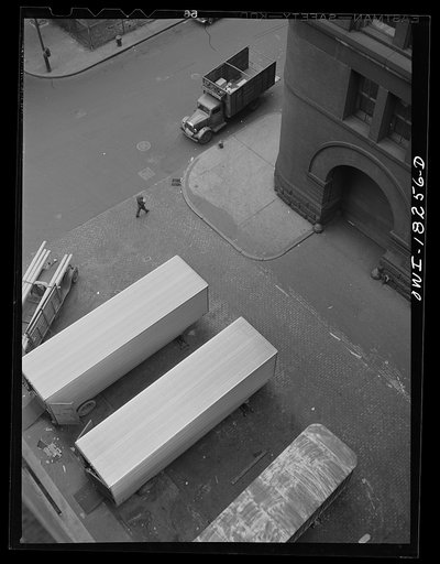 New York, New York. Associated Transport Company trucking terminal on Twenty-third Street. Main line and local delivery trucks at the loading platform