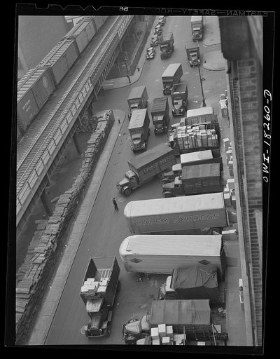 New York, New York. Associated Transport Company trucking terminal on Twenty-third Street. Main line and local delivery trucks at the loading platform