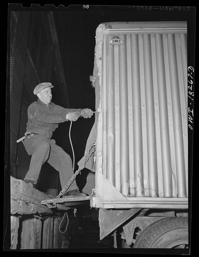 New York, New York. Associated Transport Company trucking terminal on Twenty-third Street. Closing up the back of a loaded trailer