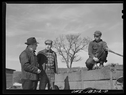 Untitled photo, possibly related to: Farm Security Administration supervisor John Tormey, left, visiting the Wisconsin farm of Loren Colby (center), to discuss the progress of Harvey G. Berthold who was placed on the farm as a hired hand through the farm short course at the University of Wisconsin