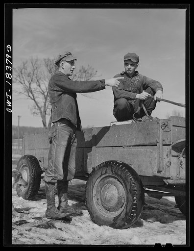 Untitled photo, possibly related to: Farm Security Administration supervisor John Tormey, left, visiting the Wisconsin farm of Loren Colby (center), to discuss the progress of Harvey G. Berthold who was placed on the farm as a hired hand through the farm short course at the University of Wisconsin