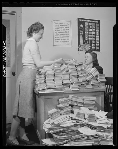 Washington, D.C. Government workers handling requests for Office of War Information (OWI) publication "Tale of a city" at the United States Information Center