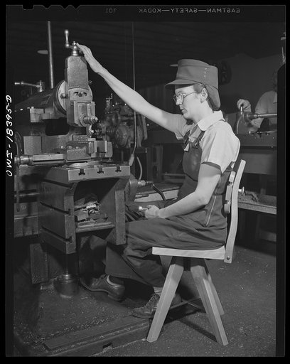 Washington, D.C. Woman worker in a wartime machine shop using a chair designed to rest her back and be manufactured with a minimum use of metal