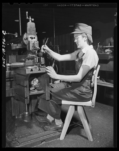 Washington, D.C. Woman worker in a wartime machine shop using a chair designed to rest her back and be manufactured with a minimum use of metal