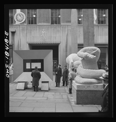 New York, New York. "United Nations" exhibition of photographs presented by the United States Office of War Information (OWI) on Rockefeller Plaza. Listening to broadcasts of President Roosevelt, Churchill, Stalin, and Chiang Kai-Chek, heard every half-hour from a loudspeaker at one end of the frame