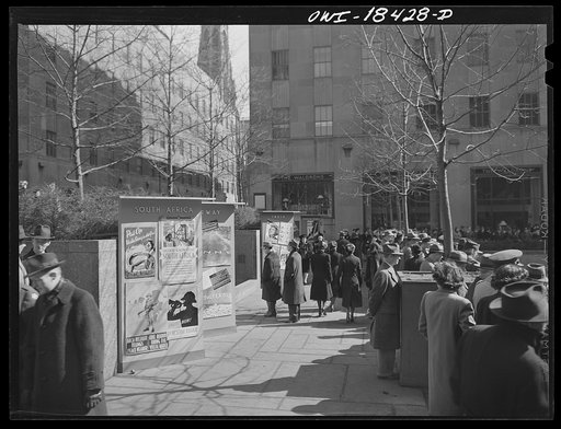 New York, New York. "United Nations" exhibition of photographs presented by the United States Office of War Information (OWI) on Rockefeller Plaza. Posters of all nations displayed on colored boards around edge of the skating rink