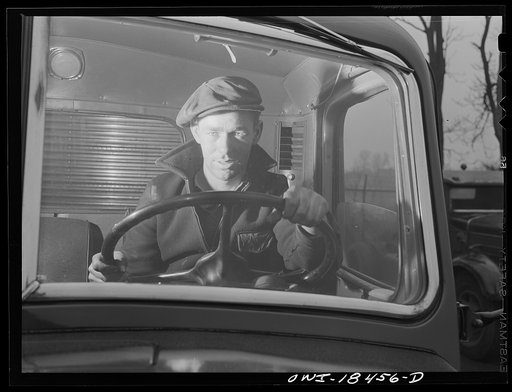 Baltimore, Maryland. Associated Transport Company trucking terminal. "Yard jockeys" or "spotters" drive trucks around the terminal and back them up to the loading platform