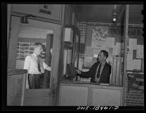 Baltimore, Maryland. Associated Transport Company trucking terminal. Driver receiving his log from the dispatcher's office before going out on the road. This case contains the manifest and bills of lading for the freight he is to carry, and cannot be opened until he arrives at the receiving terminal