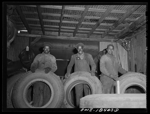 Untitled photo, possibly related to: Baltimore, Maryland. Associated Transport Company trucking terminal. Worker in the tire repair shop
