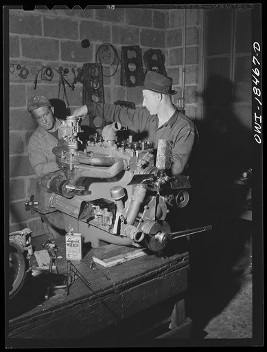 Baltimore, Maryland. Davidson Transfer Company trucking terminal. Overhauling the engine of a truck