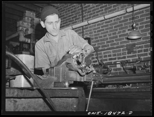 Baltimore, Maryland. Associated Transport Company trucking terminal. Reconditioning the generator of a truck