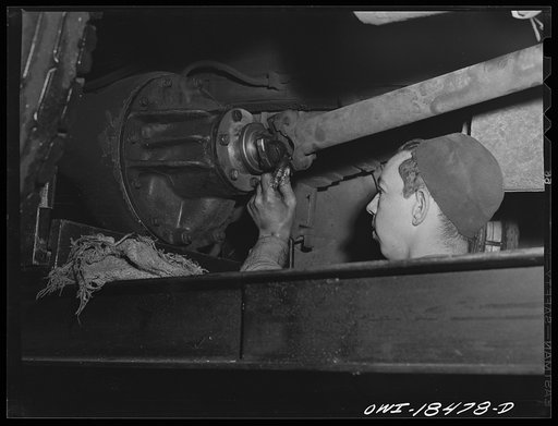 Untitled photo, possibly related to: Baltimore, Maryland. Davidson Transfer Company trucking terminal. Checking the tires on truck tractors
