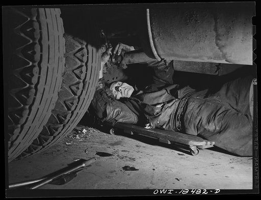 Baltimore, Maryland. Associated Transport Company trucking terminal. Mechanic working on a truck