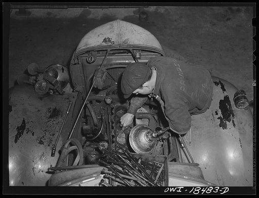 Baltimore, Maryland. Associated Transport Company trucking terminal. Mechanic working on a truck tractor