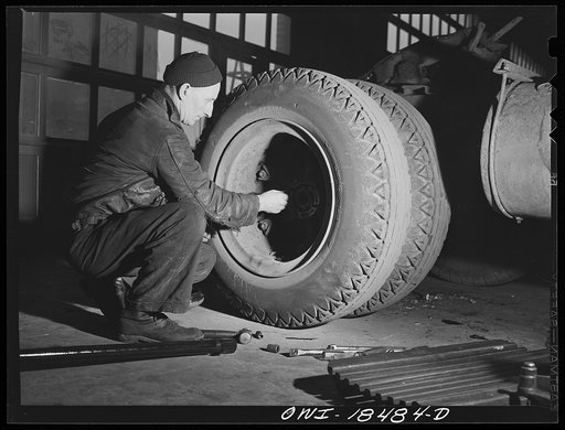 Baltimore, Maryland. Davidson Transfer Company trucking terminal. Loosening bolts to remove an axle rod in the truck service shop