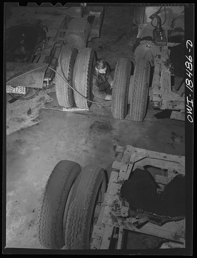 Baltimore, Maryland. Davidson Transfer Company trucking terminal. Checking the tires on truck tractors