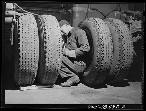 Baltimore, Maryland. Davidson Transfer Company trucking terminal. Checking the tires on truck tractors