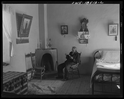 Trampas, Taos County, New Mexico. Grandfather Romero, the oldest man in the town, is ninety-nine years old (seated in room, reading)