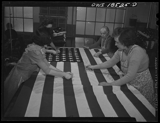 Untitled photo, possibly related to: Verona, New Jersey. Women trimming threads from a flag made for the government at the Annin Flag Company